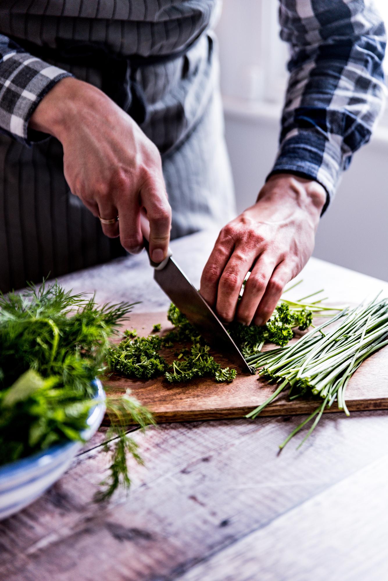 Chef hands slicing herbs